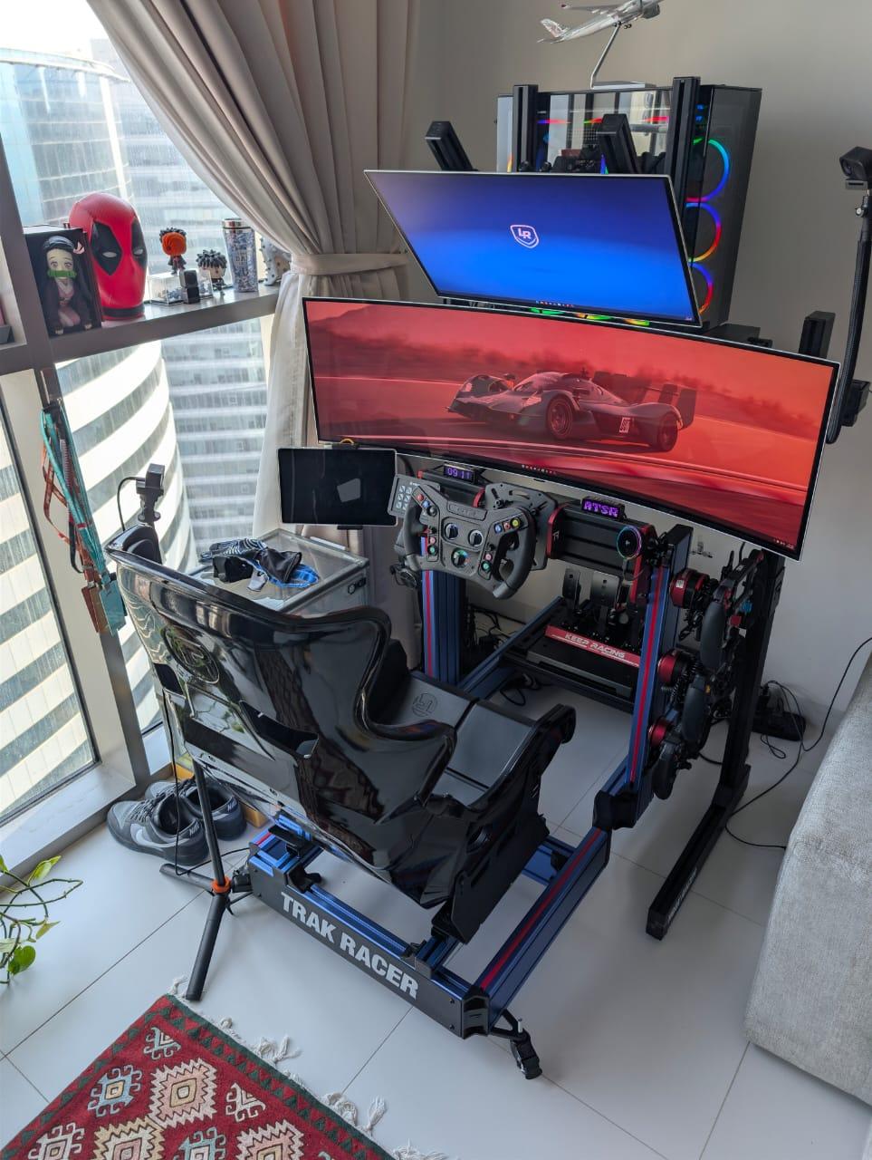 Built for uncompromising immersion, my metallic blue TR120S V2 is the backbone of the Phantom Sector sim racing cockpit. The anodized blue chassis brings a motorsport-grade aesthetic while delivering the rigidity and adjustability serious endurance racing demands. Paired with a GT-style seat, ultra-wide display, and precision-mounted controls, this rig is tuned for long stints, consistent inputs, and full race-day immersion.

Every element is positioned with intent—from wheelbase and pedal geometry to auxiliary displays and tactile feedback—creating a cockpit that feels less like a setup and more like stepping into a modern Hypercar. The metallic blue finish ties it all together with a bold, signature look that stands out on stream and on grid.