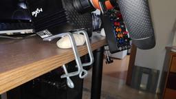 2 c-clamps for DIY deskmount and a white rock to angle the wheel to 15degree angle
